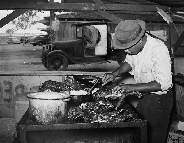 Man slicing barbecue at the Gonzales County Fair