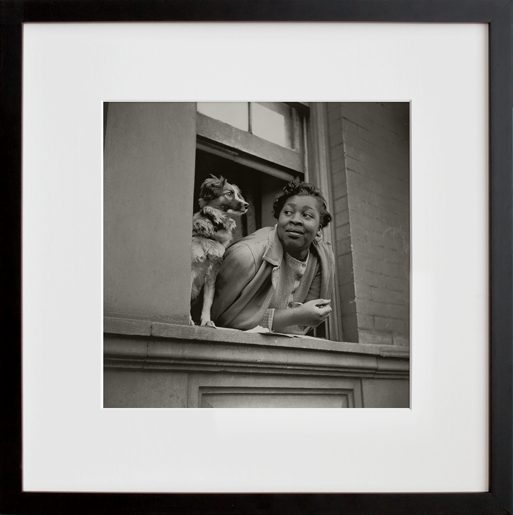 A woman and her dog in the Harlem section in a black frame