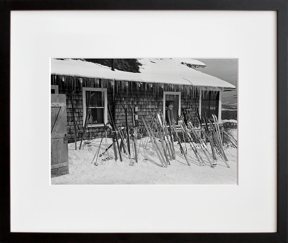 Skis outside of tollhouse at the foot of Smugglers Notch in a black frame