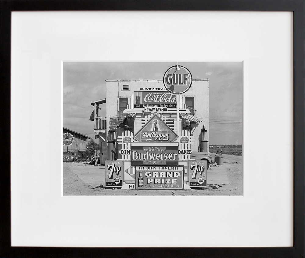 Signs in front of highway tavern. Crystal City, Texas in a black frame