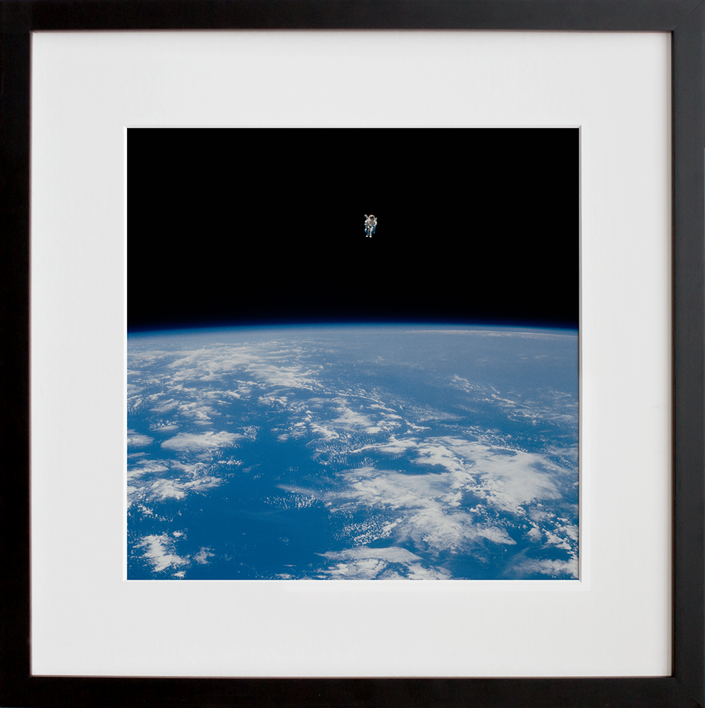 Views of the extravehicular activity during STS 41-B in a black frame