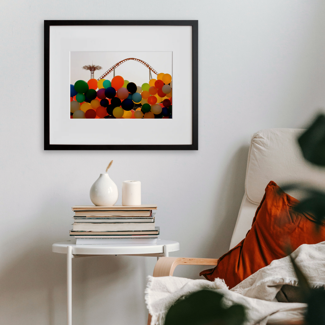Untitled (Balloons) in a black frame on a wall