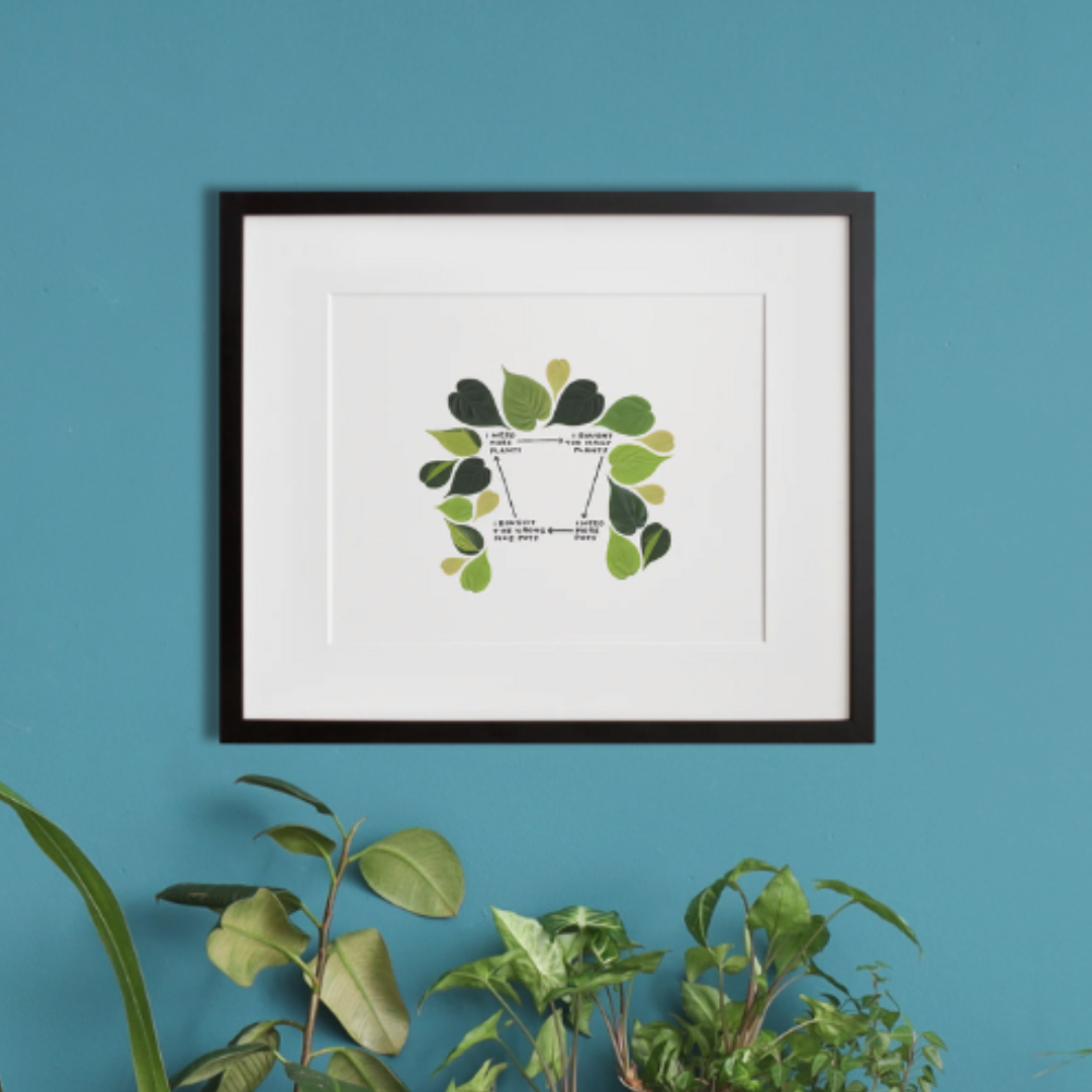 Plant Parenthood in a black frame on a wall