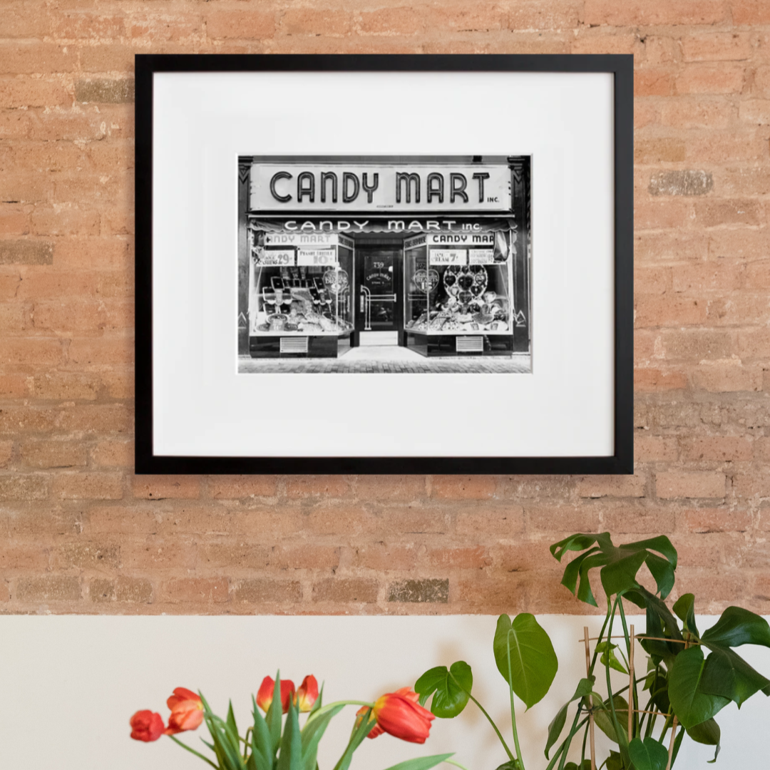 Candy Mart in a black frame on a wall