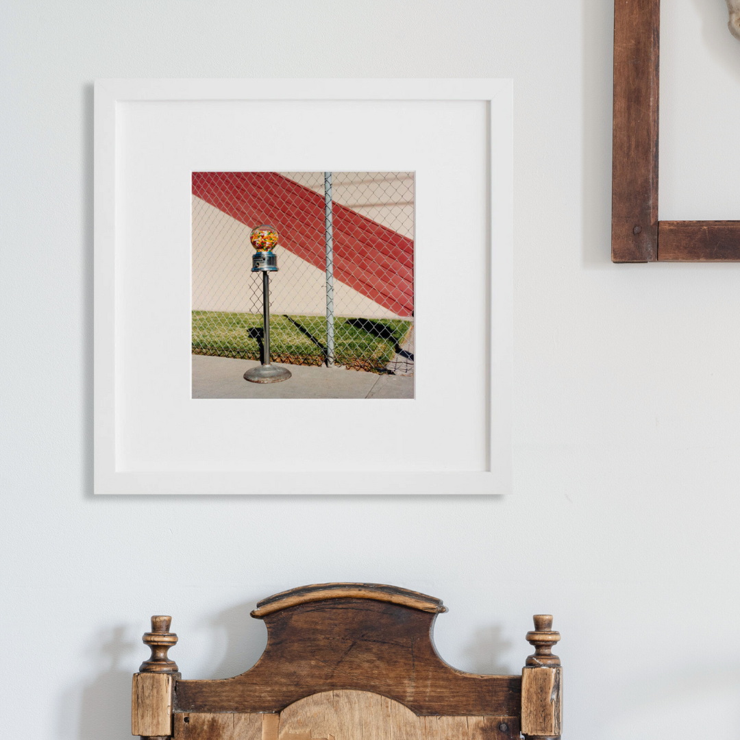 Gumball Machine in a white frame on a wall