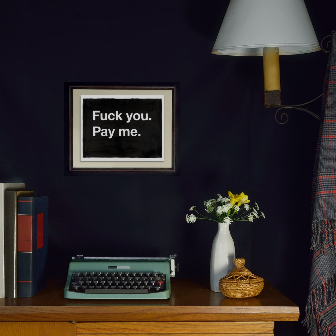 F--- you. Pay me. in a black frame on a wall