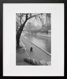 A couple walking along the Seine River in Paris