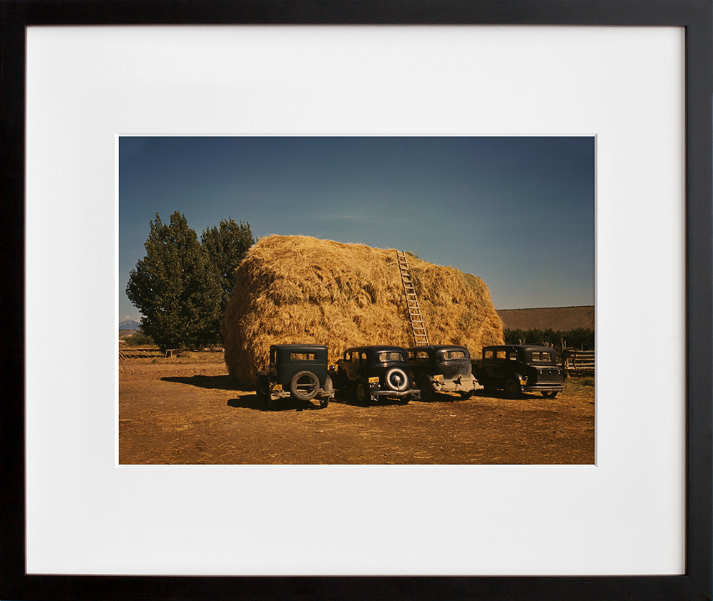 Hay stack and automobile of peach pickers, Delta County, Colorado in a black frame