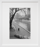 A couple walking along the Seine River in Paris