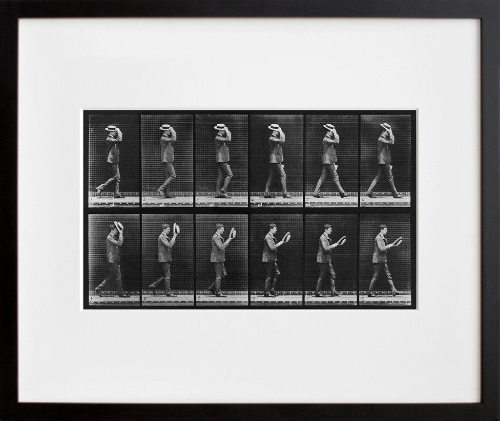 Animal Locomotion: Plate 44 (Man Taking Off Hat) in a black frame