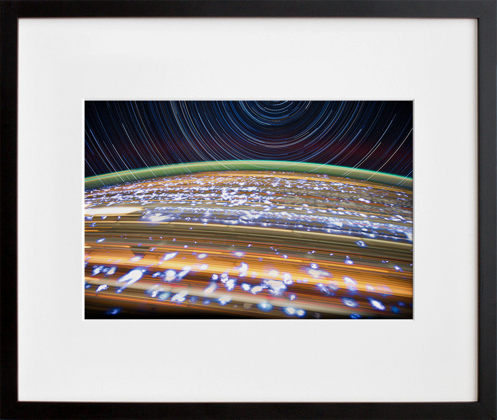 jsc2012e052681: star trails over Earth at night, in a black frame
