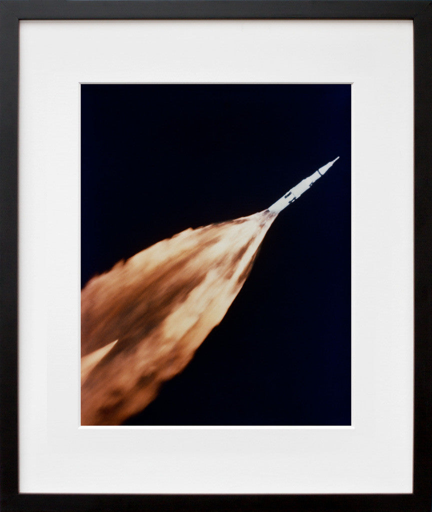 S68-27366: a Saturn V rocket on a trail of flame, in a black frame