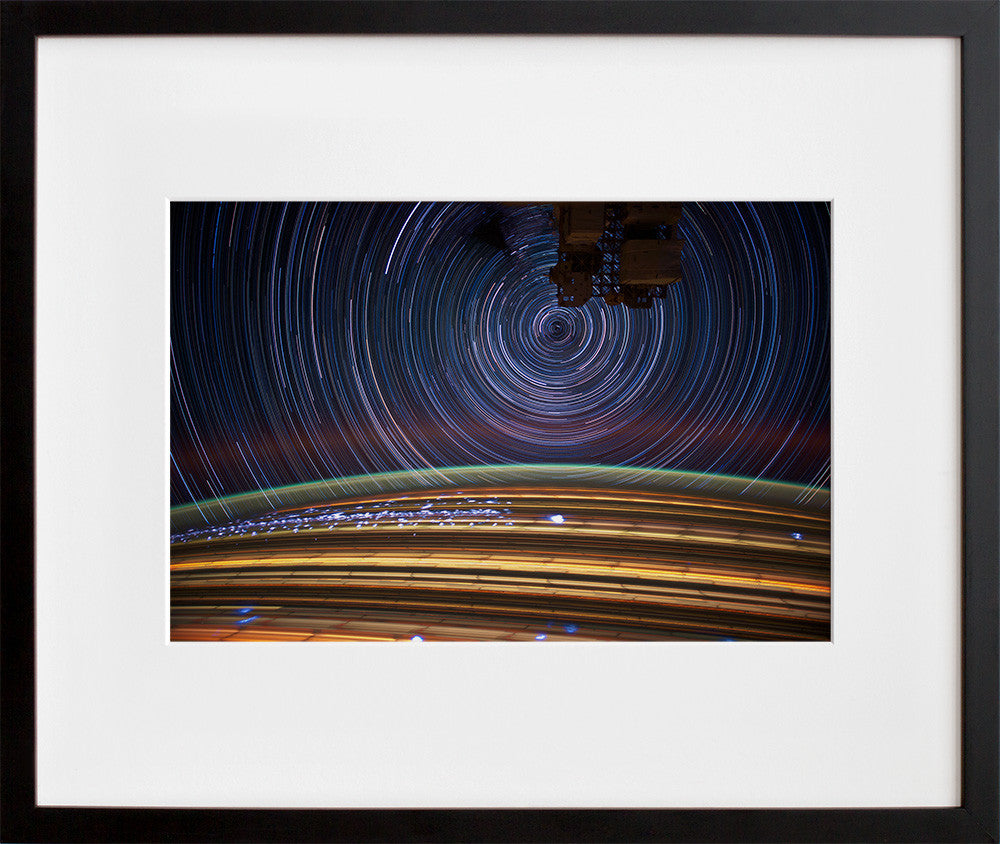jsc2012e052683: circular star trails above Earth, in a black frame