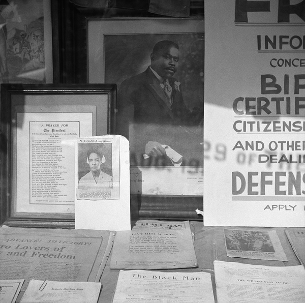 Signs in the windows of a Marcus Garvey club in the Harlem area